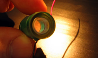 Small piezo tunable air spaced etalon 	A tunable Fabry Perot etalon uses piezo electric cylinders to adjust the size of the air gap and sweep the peaks of the etalon Image for piezoetalonjpg